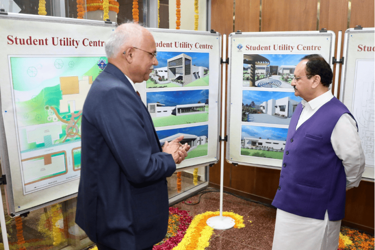 Prof Saraf showing student utility center blueprint to Hon'ble Union Minister